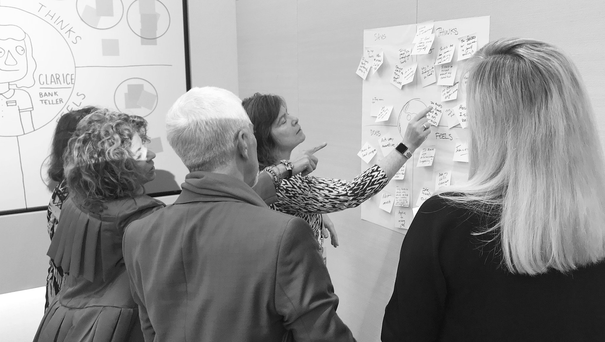 Business team strategizing at a white board